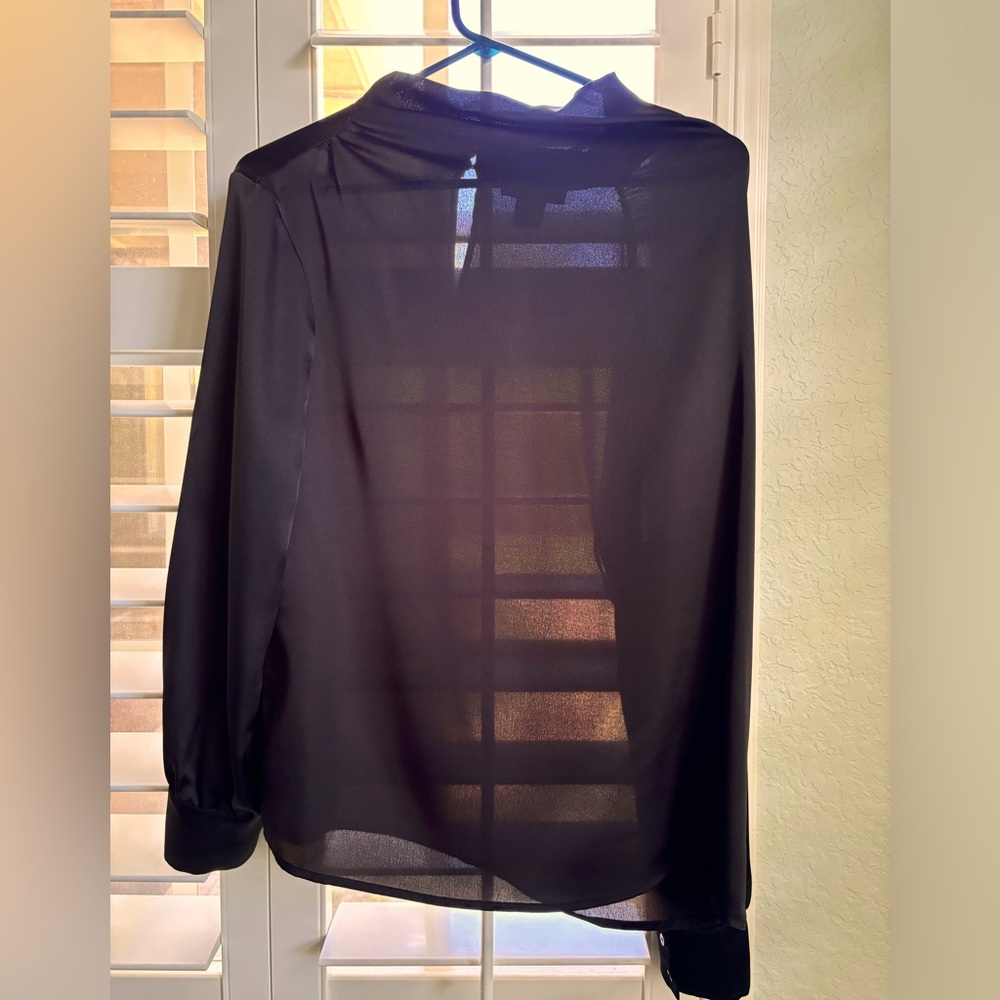 Slightly sheer black cowl neck blouse with buttons on back neck.